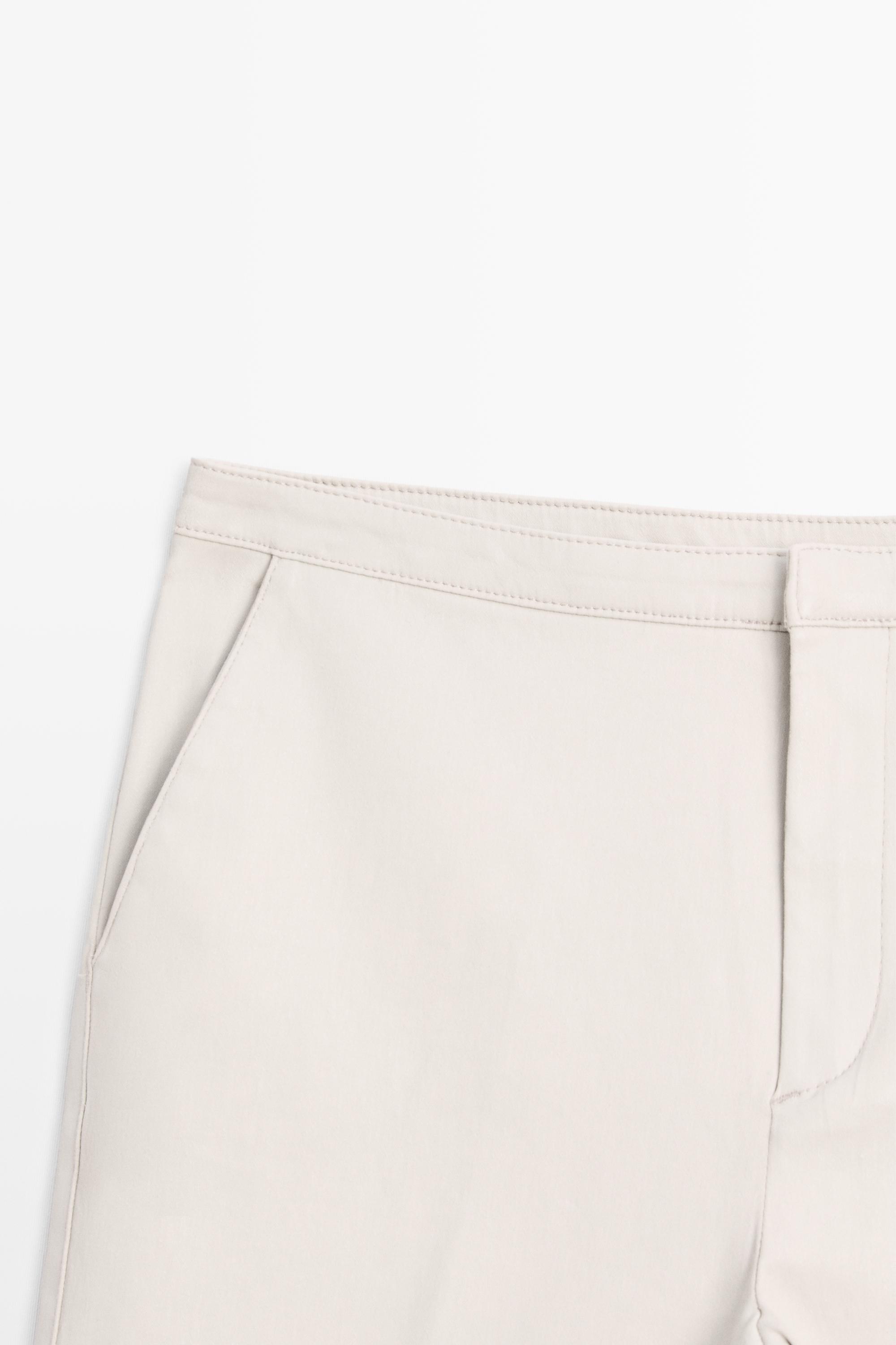 Pantalon flare taille moyenne enduit